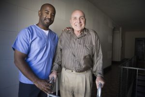 Health care worker with elderly man